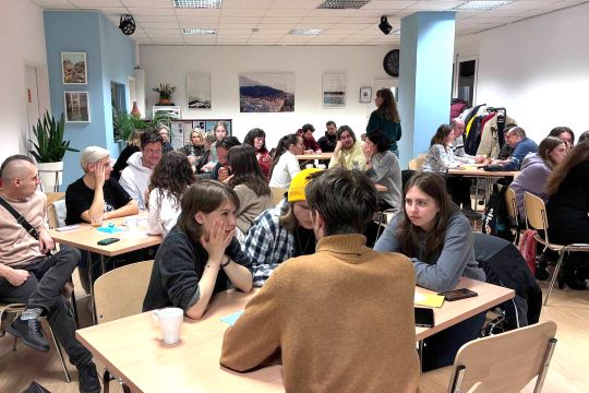 Teilnehmende diskutieren in Teams beim Quizabend „Eine Minute zum Nachdenken“ über die Ukraine